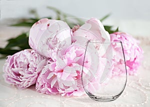 Mockup - stemless wine glass, with peonies behind