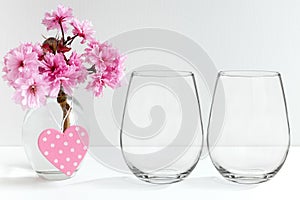 Mockup - stemless wine glasses, blossom in a vase