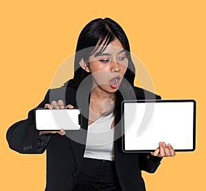 Mockup of a surprised woman showing a smartphone and a tablet with summer themed orange background
