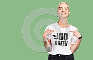 Mockup, sustainable fashion and green background, woman with tshirt and space for eco friendly product placement