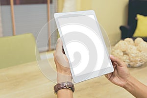 Mockup tablet on businessman hands empty display on home table with blur background. - Image - Image