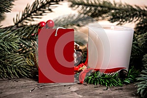 Mockup tag paper card with candle christmas decoration on wood