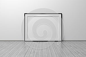 Mockup template of A4 frame with thin black frame border standing next to wall on wooden floor