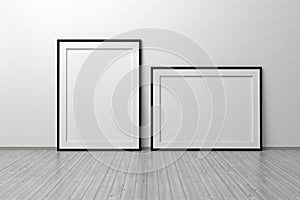 Mockup template of two A4 frame with thin black frame border standing next to wall on wooden floor