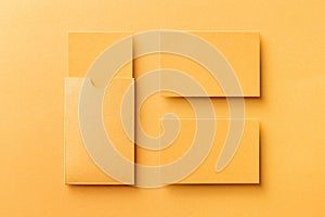 Mockup of two blank business cards and a cardholder at golden paper