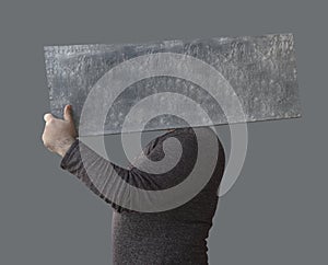 mockup. unrecognizable man holding behind head blue, grey blank picture painting board. mock up template. male painter holding