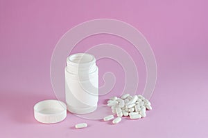 Mockup vitamin complex from beriberi jar and capsules granules tablets pink background