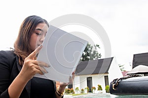 Mockup of a white blank hardcover book featuring a woman reading it near a pool