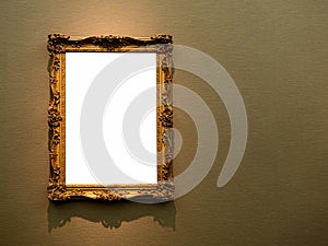 Mockup white blank space in classic gold wooden square louise style frame hanging on dark background.