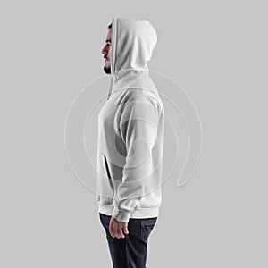 Mockup of white hoodie on bearded man in hood, side view, oversized clothes with pocket, laces, label, isolated on background