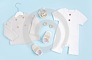 Mockup of white infant bodysuit made of organic cotton with eco friendly baby accessories