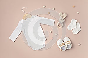 Mockup of white infant bodysuit made of organic cotton with eco friendly baby accessories