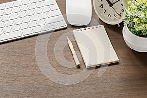 Mockup of white keyboard, mouse, blank notebook, pencil,alarm cl