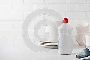 A mockup of a white plastic bottle with liquid dishwashing detergent. Banner. Copy space.