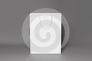 Mockup of white shopping bag isolated over dark grey paper background