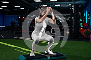 Mockup of womens white sportswear, t-shirt, leggings on girl exercising in the gym
