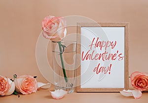 Mockup Wooden frame with text HAPPY VALENTINES DAY on delicate pink roses on beige background. Minimal trendy