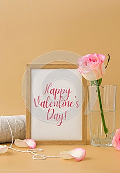 Mockup Wooden frame with text HAPPY VALENTINES DAY on delicate pink roses on beige background. Minimal trendy