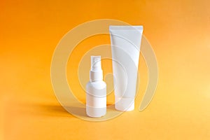 Mockups of two unbranded white bottle for branding and label on a textured bright orange background.