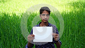Advertisement and model industry concept. Young Indian boy posing in green field for a Model advertisement company