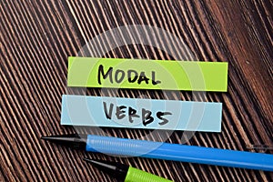 Modal Verbs write on sticky notes isolated on office desk photo