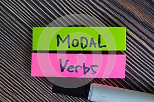 Modal Verbs write on sticky notes isolated on Wooden Table