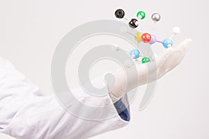 Model atom on hand with white background