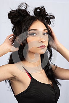 model with black hair with half up down space buns hairstyle style rave event fun fashion beauty