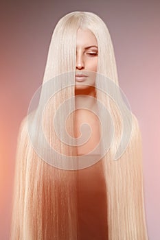 Model blonde with long healthy shiny hair. Woman wearing hair