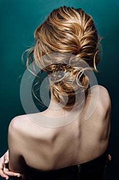 Model blonde Woman with perfect hairstyle and creative hair-dress, back view.