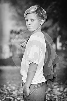 Model boy trying various poses for monochrome portrait photos in skate park