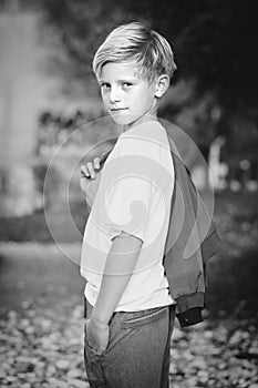 Model boy trying various poses for monochrome portrait photos in skate park