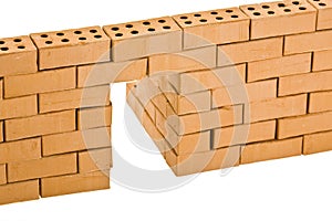 Model brick wall with open door - building construction and construction industry concept