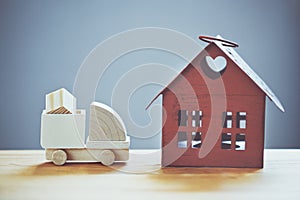 Model of cargo truck delivering box to house