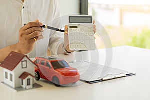 Model cars and houses with agents and customers discussing contracts, insurance, or real estate, or property history loans. Ideas
