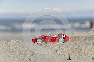 Model of a classic Formula one car on the beach
