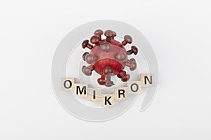 Model of corona virus with the word omicron as symbol for the new covid-19 mutant virus from south africa photo