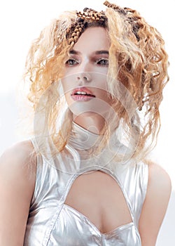 Model with creative futuristic hair style and silver clothes