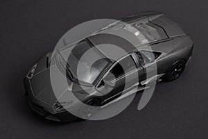 Model of a dark sports car on a dark background