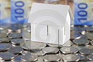 Model of detached house, Swiss coins and banknotes