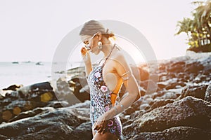 Model in ethnic monokini and wearing boho jewellery