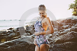 Model in ethnic monokini and wearing boho jewellery