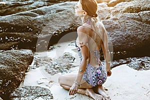 Model in ethnic monokini and wearing boho jewellery