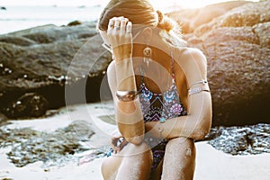 Model in ethnic monokini and wearing boho jewellery