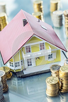 Model familly house with coins as bank or insurance concept