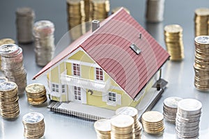 Model familly house with coins as bank or insurance concept