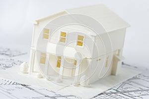 Model of the family house printed on a 3D printer with white filament by FDM technology for architectural use.