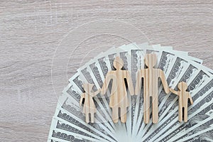 Model family and usd dollar money on wooden background,Save money for prepare in future and family finance concept