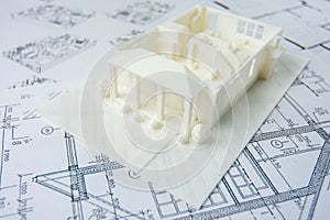 Model of the first floor of a family house printed on a 3D printer with white filament by FDM technology for