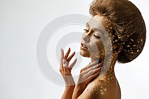 Model girl with holiday golden shiny professional makeup.